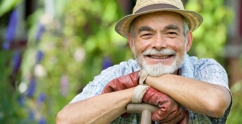 Grandpa smiling with a shovel. alert1 medical alert system